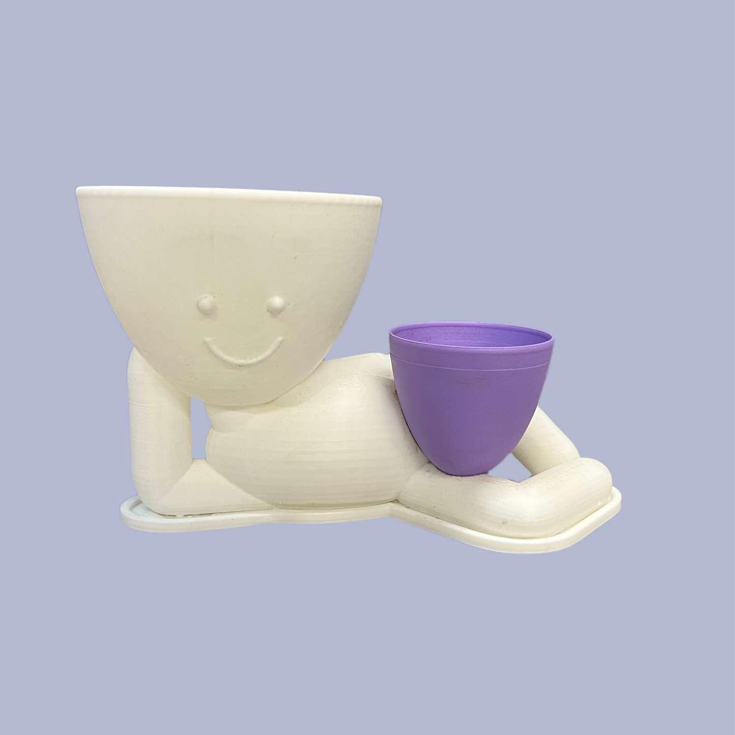 A beige figurine of a smiling planter with a purple tulip, designed to be a humorous addition to home decor.