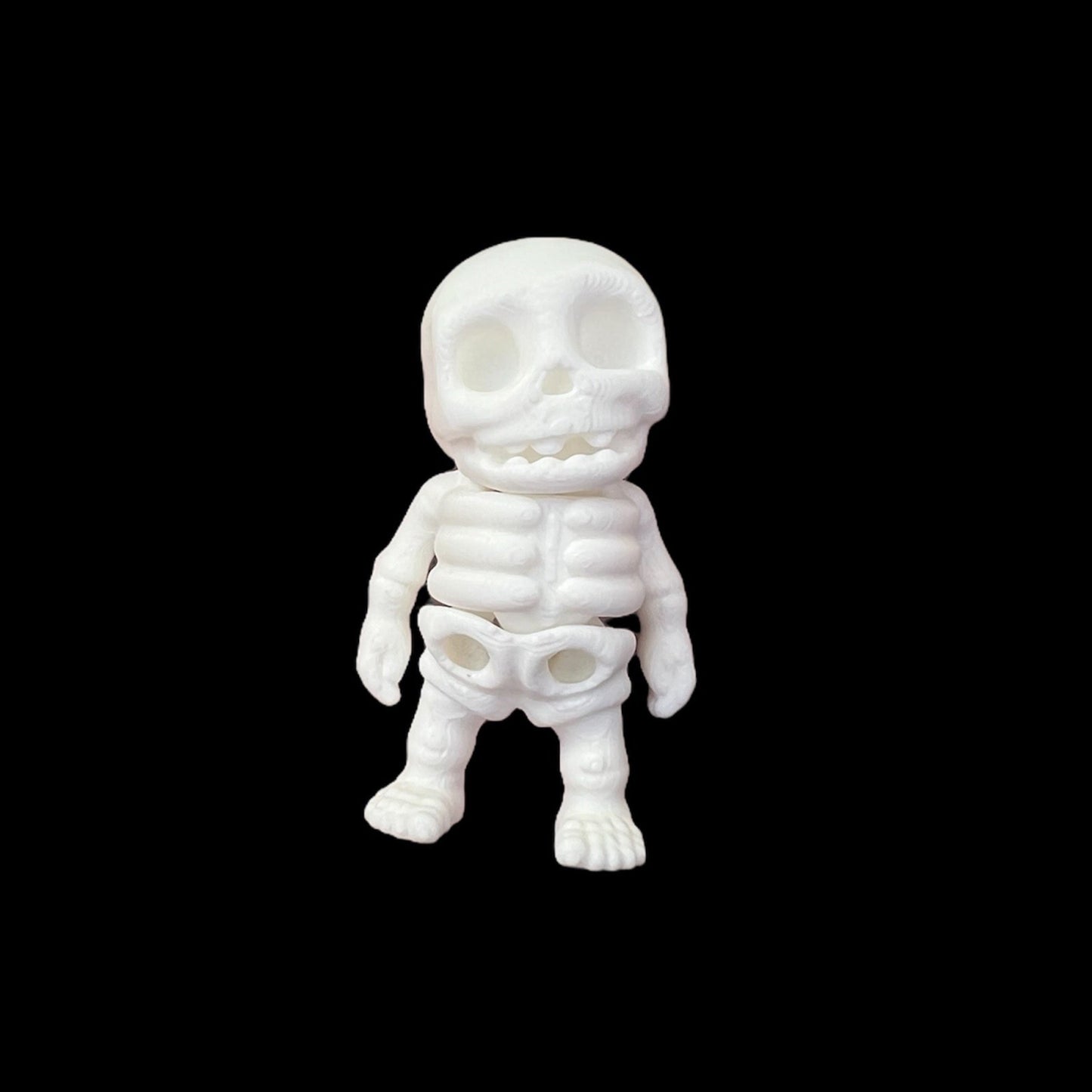 A white plastic skeleton figure with a smiling face.