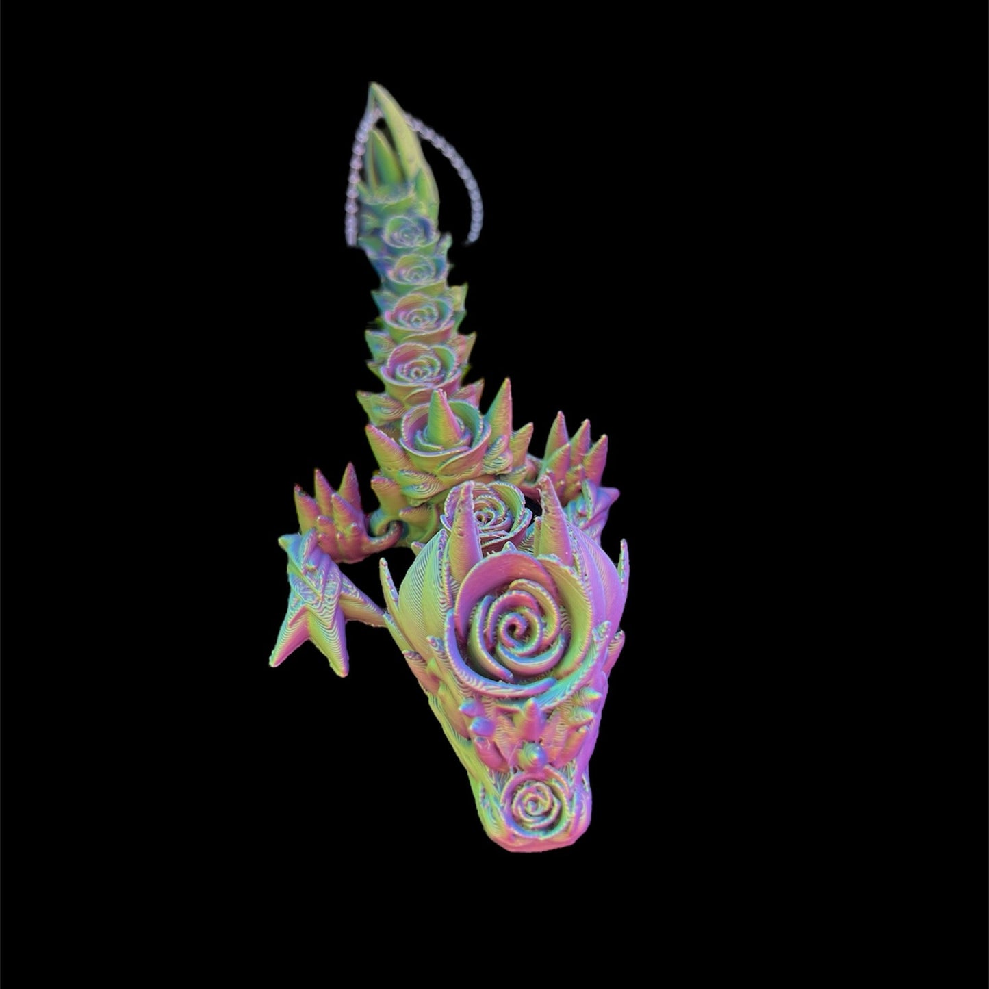 A multicolored 3D printed sculpture of a fantastical dragon with a rose-like pattern on its body.